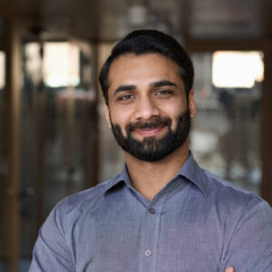 Portrait of young happy indian business man executive looking at camera. Eastern male professional teacher, smiling ethnic bearded entrepreneur or manager posing in office, close up face headshot.